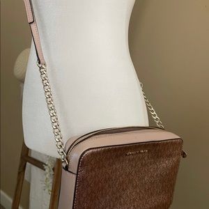 Michael kors rose gold crossbody bag with a matching key ring card wallet.